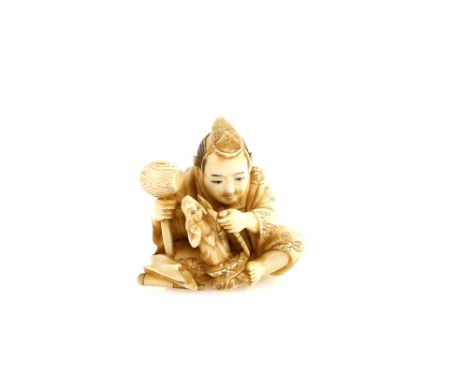 A stained ivory netsuke carved as an okimono sculptor with a large hammer in his right hand, signed SeishoProvenance: The Pro