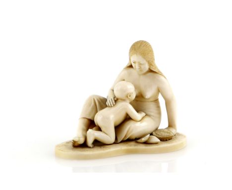 A stained ivory okimono carved as a mother feeding her baby, signed on a red reserve, 6.5 cm wide, 19th or 20th CenturyProven