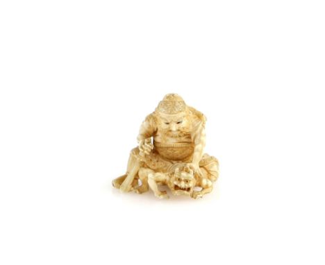 An ivory netsuke of Shoki holding a sword in his right hand and holding down an Oni,  un-signedProvenance: The Property of a 