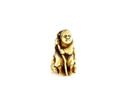 A stained ivory netsuke of a Sennin on a rock, signed TomohisaProvenance: The Property of a Lady. From a Private Collection a