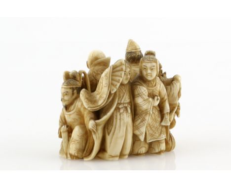 An okimono style netsuke carved as a number of standing scholars, courtiers or other figures, 19th or 20th CenturyProvenance: