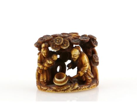 A stained ivory netsuke with central himotoshi on the base carved as the story of Hanasaka Jiji (The Old Man who makes the De