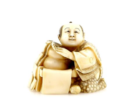 A stained ivory netsuke of a seated man with O-mochi cakes, signed Shuzan in an oval reserve.Provenance: The Property of a La