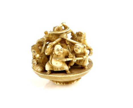 An okimono style netsuke of the Shichifukujin in a massive sakazuki; the himotoshi on the base of the cup, 6 cm high, Meiji P