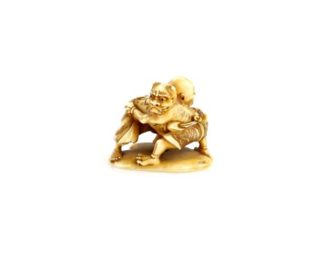 A stained ivory netsuke with central himotoshi designed as an Oni and gaki, sumo wrestling; signed on the base ToshiharuProve