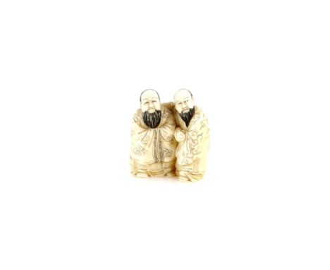 A small stained ivory okimono of two standing scholars, 3cm high, 20th CenturyProvenance: The Property of a Lady. From a Priv