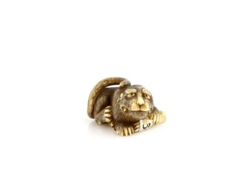 A stained ivory netsuke of a crouching tiger, signed RanteiProvenance: The Property of a Lady. From a Private Collection acqu