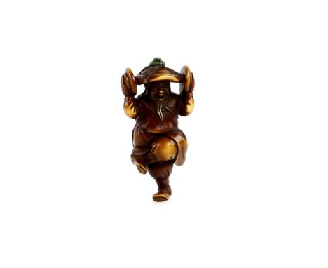 A stained ivory netsuke of a dancing man, with castanets and a wide-brimmed hat, 20th CenturyProvenance: The Property of a La