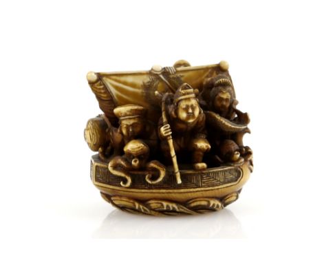 A heavily stained ivory netsuke carved as The Takarabune carrying five of The Shichifukujin; signed SoshiProvenance: The Prop