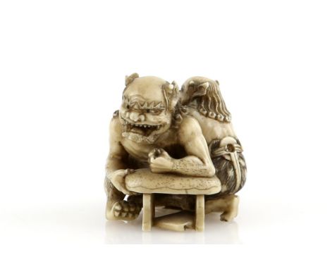 A stained ivory netsuke of two Oni, signed TomomasaProvenance: The Property of a Lady. From a Private Collection acquired by 