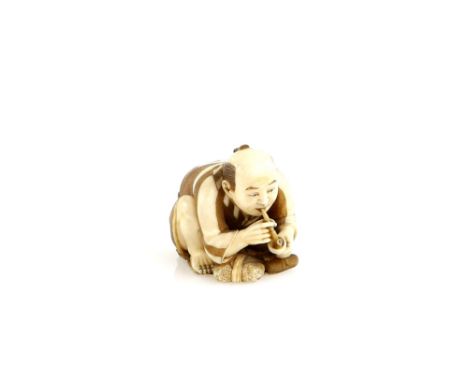 An ivory netsuke of a man smoking a pipe, 20th CenturyProvenance: The Property of a Lady. From a Private Collection acquired 