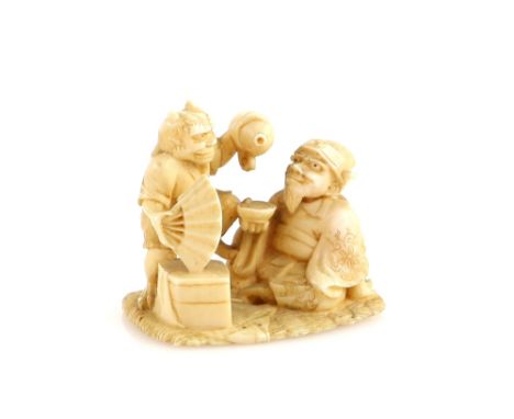 A small ivory okimono of an Oni holding a fan and pouring from a gourd flask into a chawan held by Emma-O, 19th or 20th Centu