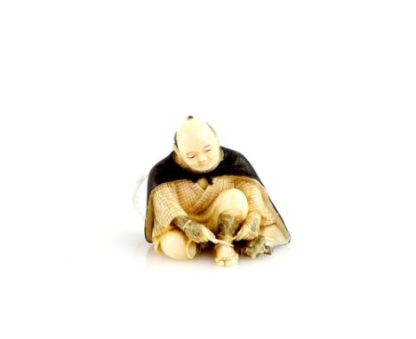 An ivory netsuke of a seated man doing up his sandal, signed SeigyokuProvenance: The Property of a Lady. From a Private Colle