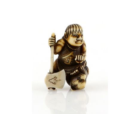 A stained ivory netsuke of Kintaro, the Golden Boy and Child of The Forest, holding an axe and standing over a bear; 19th Cen