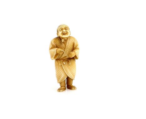 A stained ivory netsuke of a standing chanter, wearing a netsuke and sagemono, signed Yoshiyuki (Hoshi)Provenance: The Proper