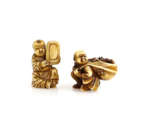 A stained ivory okimono of a boy with an inkstone, 4 cm high; together with an ivory netsuke of a traveller with a large bund