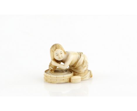 An ivory netsuke of a girl, washing her hair, signed NagamitsuProvenance: The Property of a Lady. From a Private Collection a