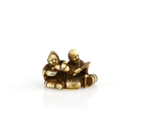 A stained ivory netsuke, carved as a man and women pouring sake beside a well bucket, signed GyokuzanProvenance: The Property