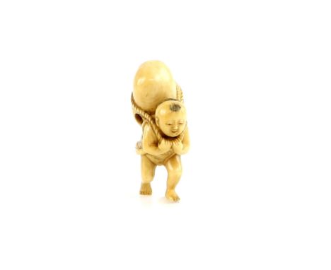 A stained ivory netsuke of a boy carrying a Daruma Doll, signed TomomasaProvenance: The Property of a Lady. From a Private Co