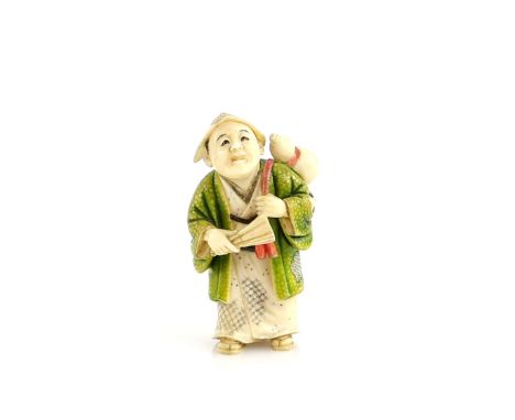 A Yasuaki (Homei) School, coloured ivory netsuke of a standing man, wearing a green kimono and carrying a gourd flask across 