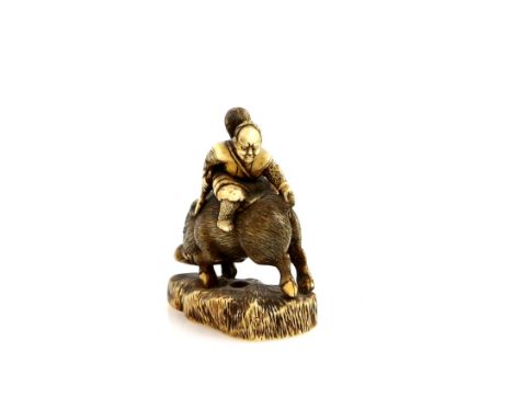 A stained ivory netsuke of the Minamoto Samurai, Nitta no Shiro, killing the boar, unsigned For a tsuba illustrating the same