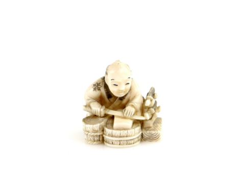 A stained ivory netsuke of a sword polisher holding a wakizashi beside a katana-kake holding two other blades, 20th CenturyPr