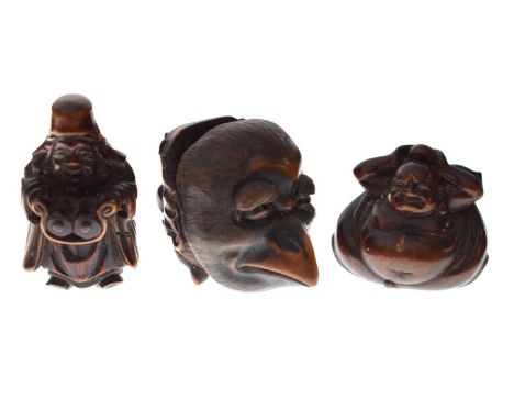 Two Japanese carved boxwood netsuke, the first modelled as Jurojin holding a scroll, 45mm high; the second modelled as Hotei 