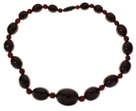 'Cherry amber' coloured bead necklace, seventeen oval black-red beads, the largest oval bead measuring 35mm x 27mm approx, th