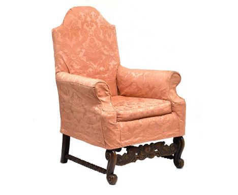 French carved walnut armchair, in the 18th century taste, the arched overstuffed back between scroll arms framing loose seat 