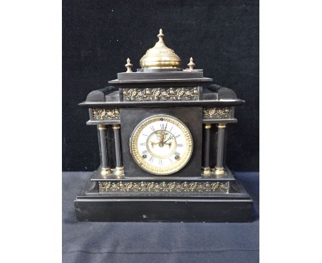 AN ANSONIA SLATE-CASED MANTEL CLOCK of architectural form, with visible escapement, striking on a gong, surmounted with a bra