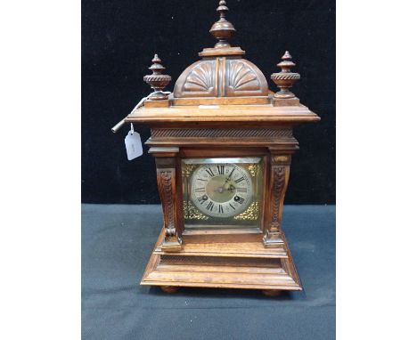 A GERMAN WALNUT CASED MANTEL CLOCK in Renaissance style with domed top, and pilasters flanking bevelled glass door, striking 