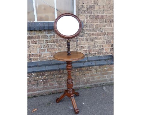 A VICTORIAN WALNUT SHAVING STAND with adjustable circular mirror, on aesthetic style tripod base, the shelf 45cm dia (some de
