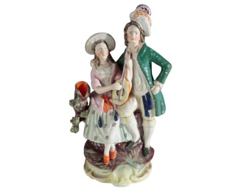 A VICTORIAN STAFFORDSHIRE POTTERY SPILL VASE, MUSICIANS modelled as a country couple, the seated lady playing a lute, on scro