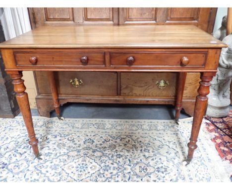 A VICTORIAN MAHOGANY SIDE TABLE, WITH TWO DRAWERS on slender turned legs with white ceramic castors 106cm wide (one odd knob)