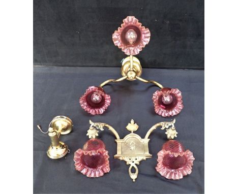 A CENTRAL LIGHT FITTING WITH CRANBERRY GLASS SHADES together with two non matching wall light with cranberry shades