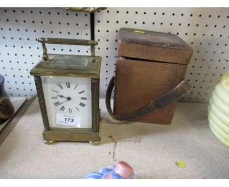 A brass cased carriage clock, with leather covered travel case