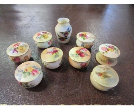 A collection of Royal Worcester covered pots, seven decorated with painted flowers, one with birds, and a miniature vase deco