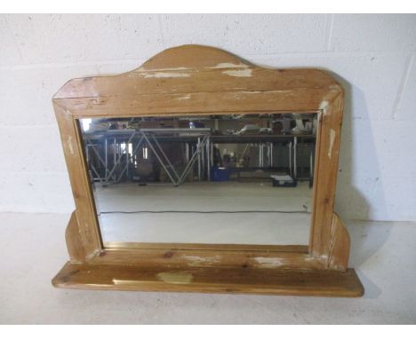 A pine overmantle mirror with shelf