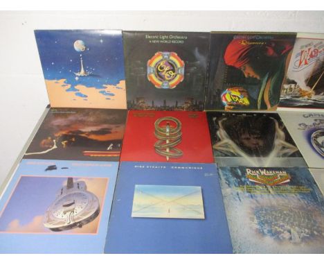 A collection of twenty seven 12" vinyl records including ELO, Dire Straits, Rick Wakeman, Camel, Santana, Genesis, Bruce Spri