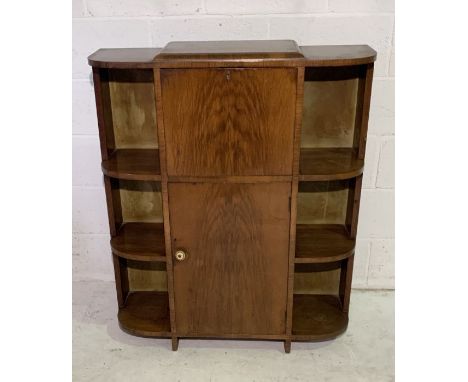 An Art Deco cupboard with drop down writing desk and cupboard under