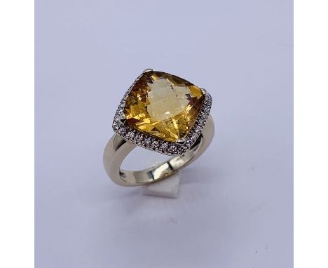 A cushion cut Citrine and diamond ring set in 18ct white gold, the centre stone approx 5-6 carats