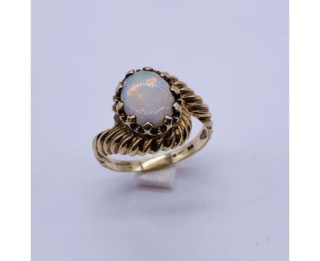 An opal ring set in 9ct gold