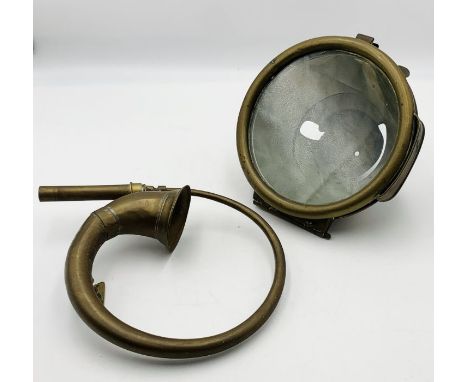 A vintage brass car lamp and horn