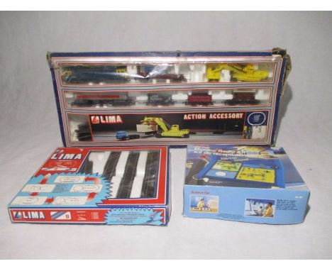 A boxed Lima model railway OO gauge Action Accessory set including a locomotive, container unloading crane lorry, rolling sto