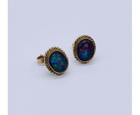 A pair of opal earrings set in unmarked 9ct gold