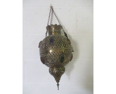 An Eastern brass hanging light decorated with cabochon stones