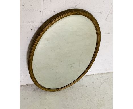 A vintage oval gilt framed mirror