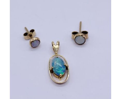 An opal pendant set in 14ct gold, along with a pair of opal earrings