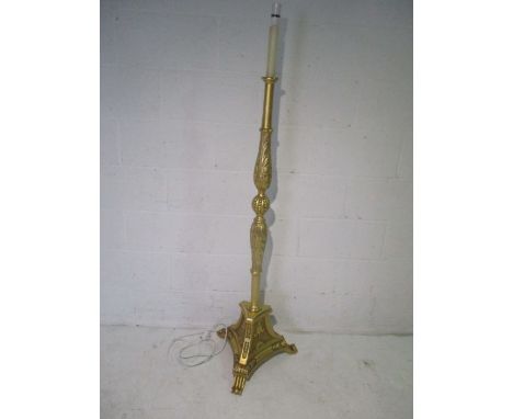  A gilt standard lamp on a tripod base.