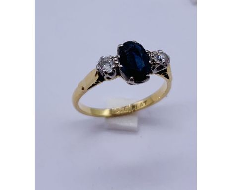 An 18ct gold and platinum sapphire and diamond three stone ring